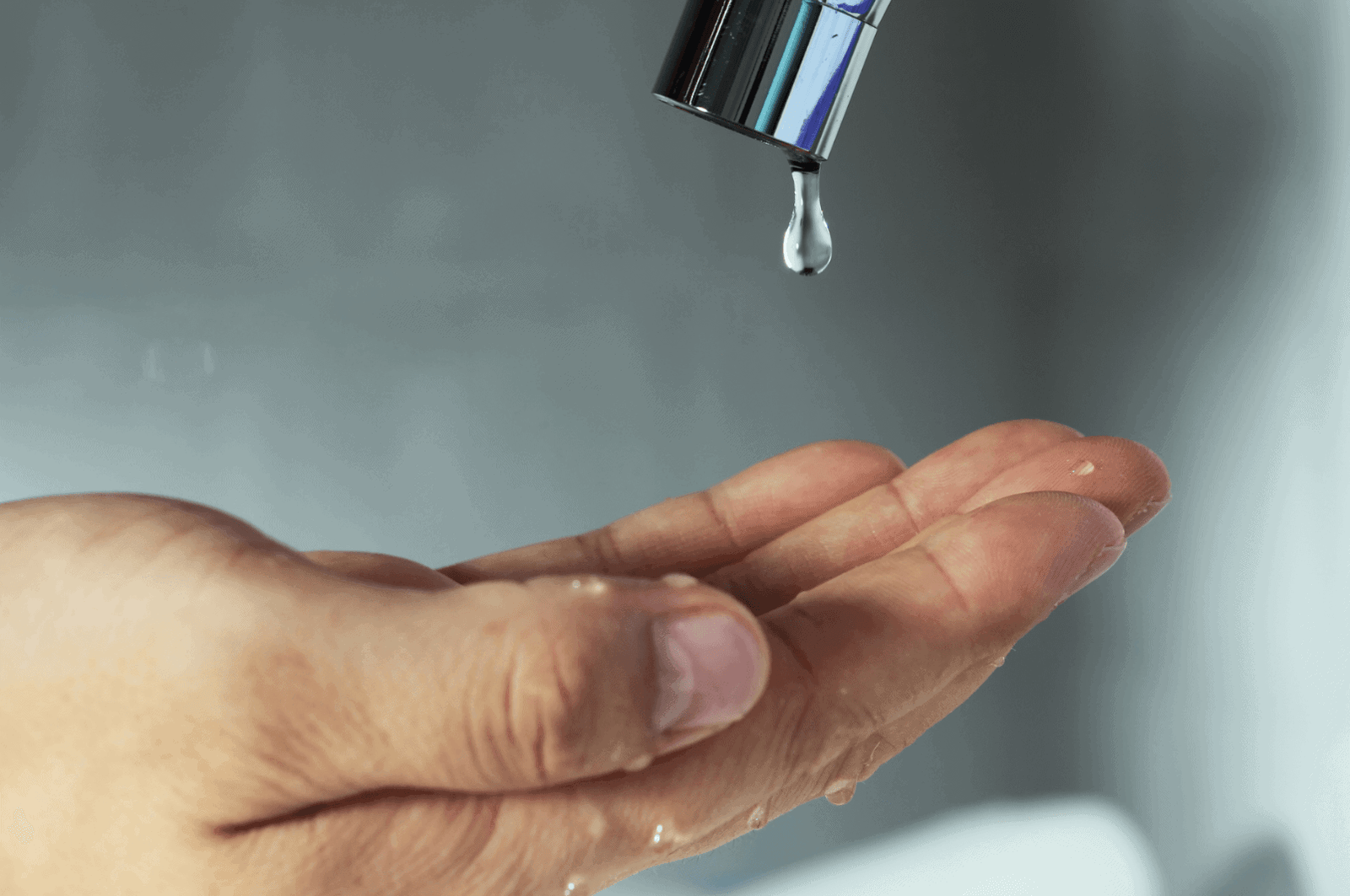 water droplet falling from faucet